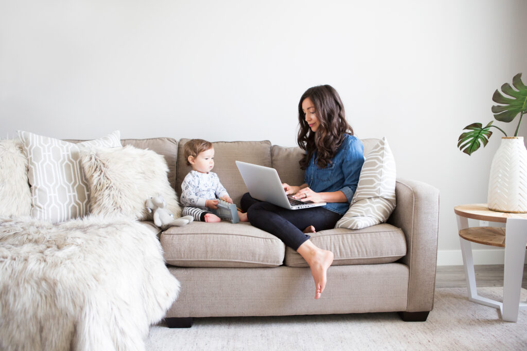 A woman and a toddler sitting on a couch