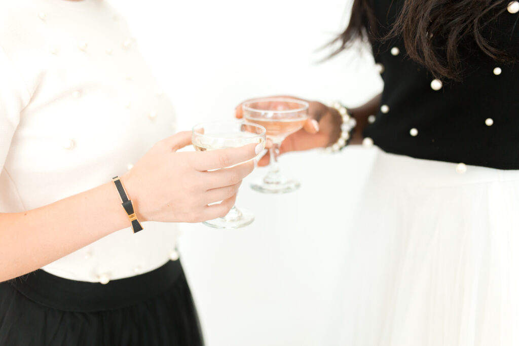 two women holding wine glasses